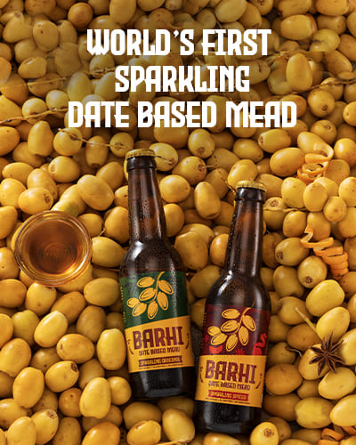 Barhi Original and Barhi Spiced date-based sparkling mead bottles placed on a bed of fresh yellow dates with text reading - World's First Sparkling Date Based Mead.