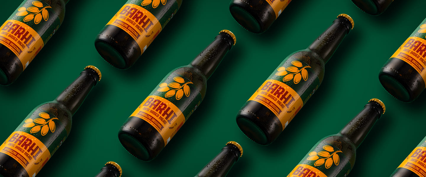 Patterned display of Barhi sparkling date-based mead bottles arranged diagonally on a green background.